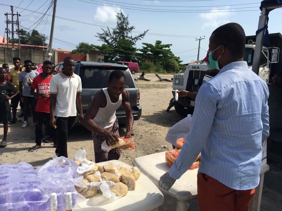 Volunteers handing out bread and water to people who came for help